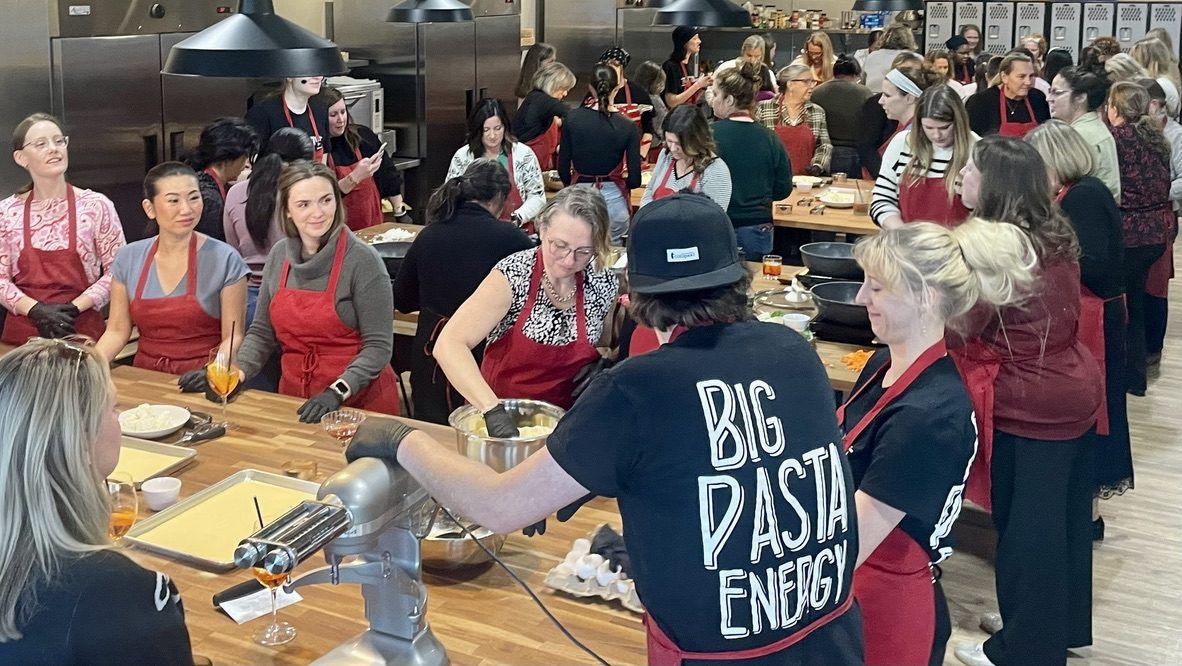 A big corporate group making fresh pasta together at The Local Epicurean.